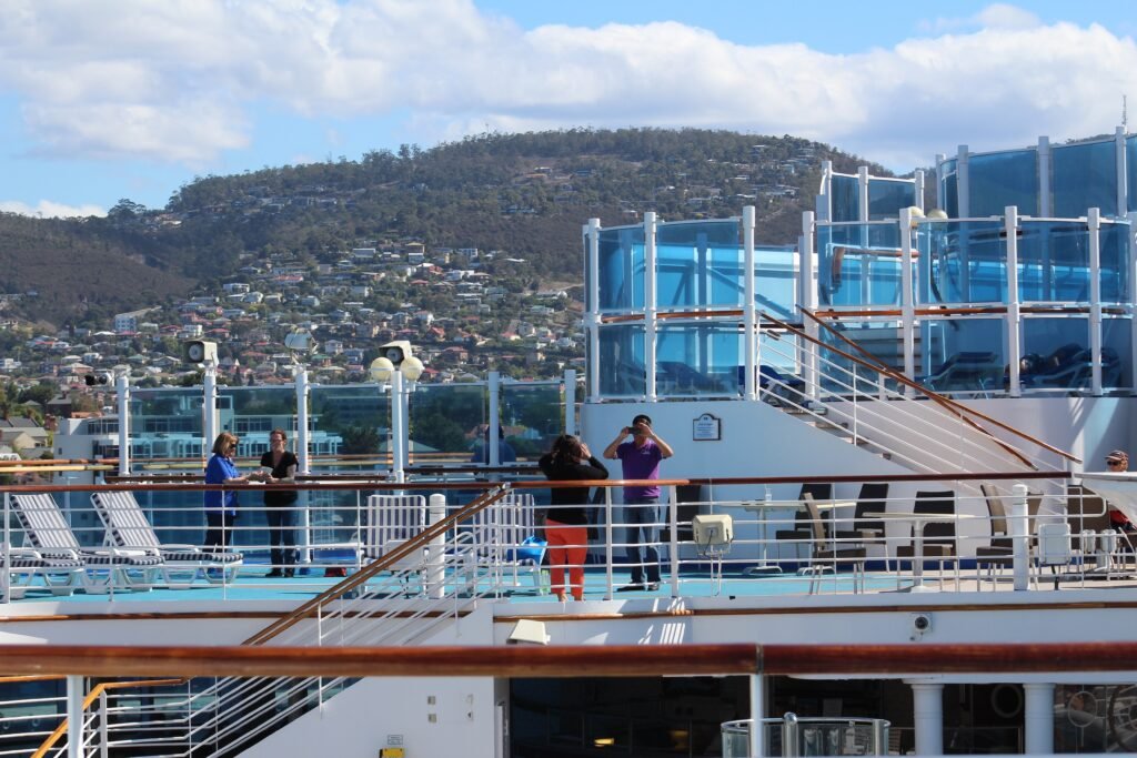 passengers relaxing on deck before cabin access